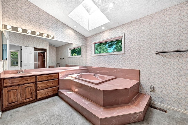 22 Marina Cir, Bella Vista, AR 72715 - bathroom featuring wallpapered walls, a skylight, vanity, a bath, and a textured ceiling
