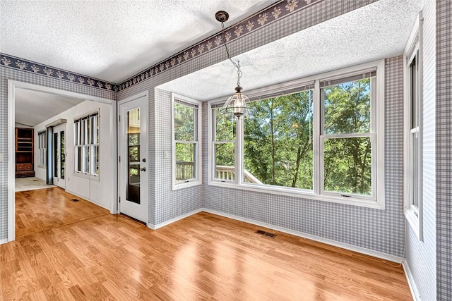 22 Marina Cir, Bella Vista, AR 72715 - unfurnished sunroom featuring wallpapered walls, a textured ceiling, wood finished floors, and baseboards