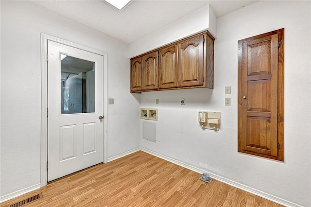 22 Marina Cir, Bella Vista, AR 72715 - washroom with light wood finished floors, washer hookup, electric dryer hookup, baseboards, and cabinet space