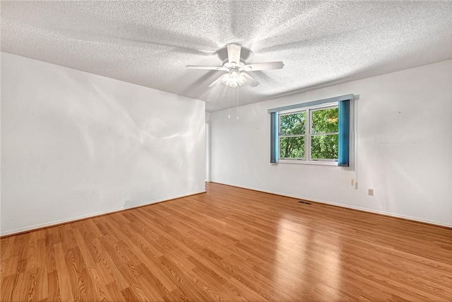 22 Marina Cir, Bella Vista, AR 72715 - empty room featuring wood finished floors, a textured ceiling, and a ceiling fan