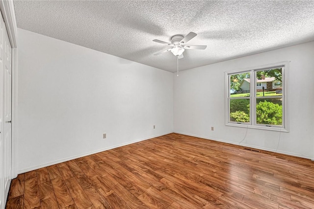 22 Marina Cir, Bella Vista, AR 72715 - spare room featuring ceiling fan, wood finished floors, a textured ceiling, and baseboards