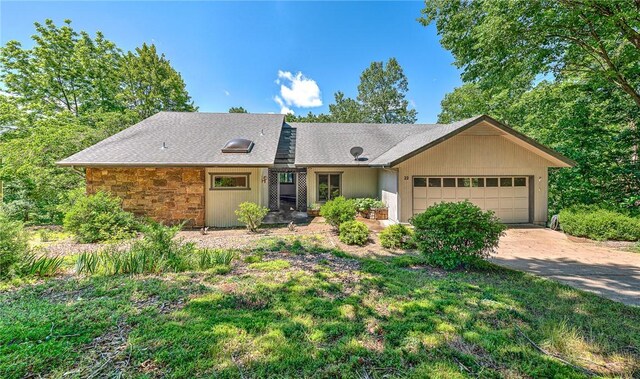 22 Marina Cir, Bella Vista, AR 72715 - view of front of property featuring an attached garage, concrete driveway, and stone siding
