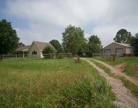 8120 N Coffelt Cemetery Rd, Bentonville, AR 72713 - view of yard with driveway, a detached garage, an outbuilding, and a view of countryside