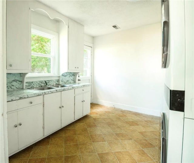 1000 Wilson Ave, Harrison, AR 72601 - kitchen featuring healthy amount of natural light and white cabinets