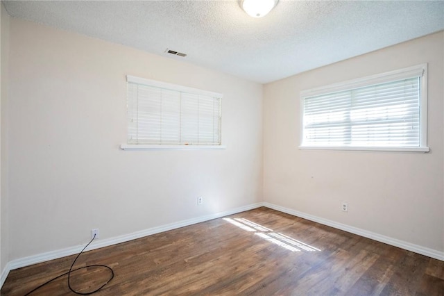 1125 E Elm St, Fayetteville, AR 72703 - empty room featuring wood finished floors, a textured ceiling, and baseboards