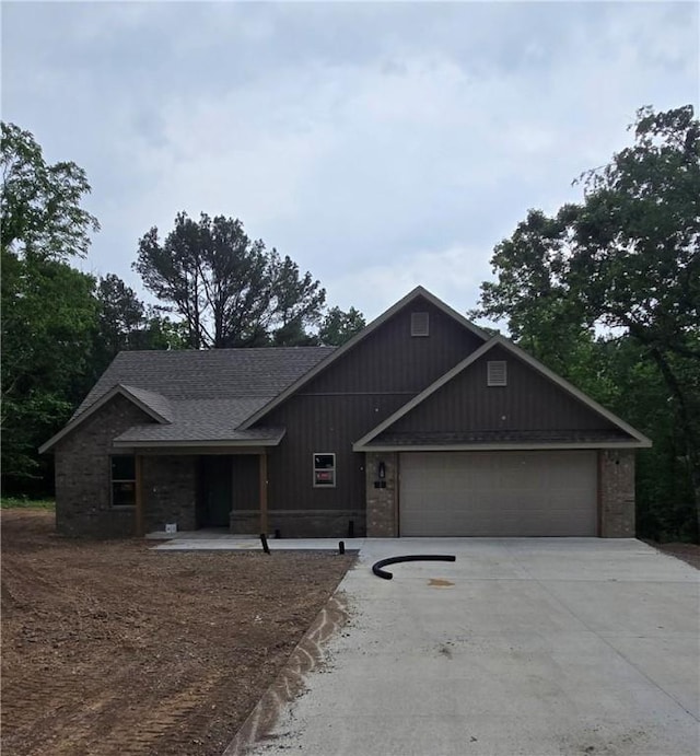 3 Drem Cir, Bella Vista, AR 72715 - view of front of home with concrete driveway, an attached garage, and a shingled roof