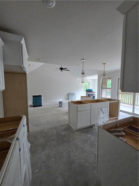 3 Drem Cir, Bella Vista, AR 72715 - kitchen with a center island, light colored carpet, white cabinetry, a ceiling fan, and decorative light fixtures