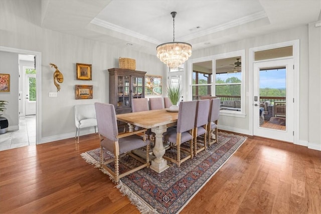 1699 E Bowen Blvd, Fayetteville, AR 72703 - dining area with wood finished floors, a tray ceiling, and ornamental molding
