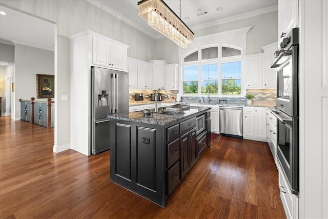 1699 E Bowen Blvd, Fayetteville, AR 72703 - kitchen featuring stainless steel appliances, a sink, white cabinets, a kitchen island with sink, and ornamental molding