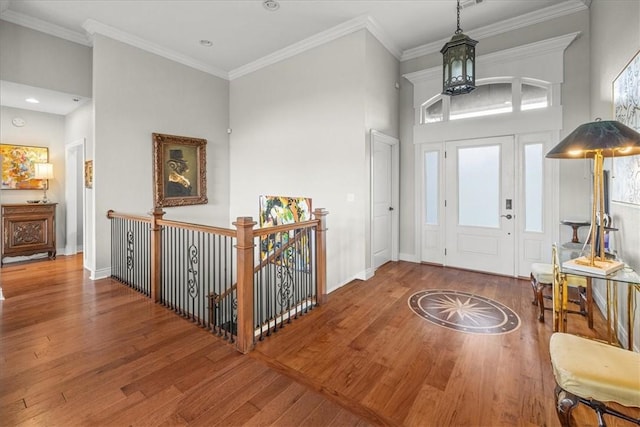 1699 E Bowen Blvd, Fayetteville, AR 72703 - foyer featuring wood finished floors, crown molding, a chandelier, baseboards, and healthy amount of natural light