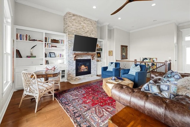 1699 E Bowen Blvd, Fayetteville, AR 72703 - living area featuring light wood finished floors, ceiling fan, ornamental molding, recessed lighting, and a stone fireplace