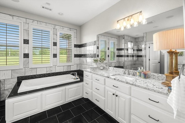 1699 E Bowen Blvd, Fayetteville, AR 72703 - full bath featuring tile walls, tile patterned floors, a bath, vanity, and tiled shower