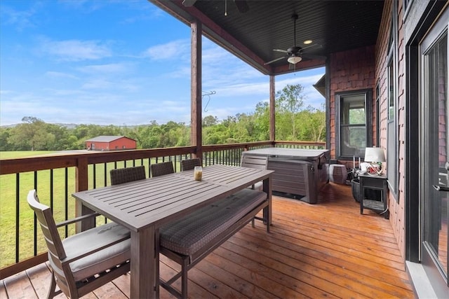 1699 E Bowen Blvd, Fayetteville, AR 72703 - deck featuring a ceiling fan, a hot tub, outdoor dining space, a yard, and view of scattered trees