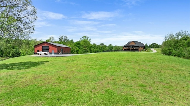 1699 E Bowen Blvd, Fayetteville, AR 72703 - view of grassy yard featuring a detached garage, an outdoor structure, and an outbuilding