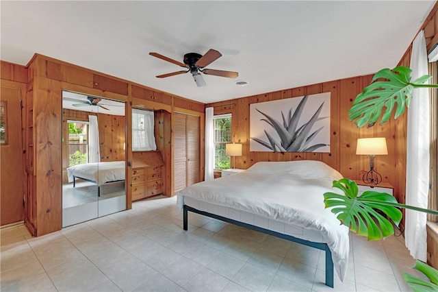 324 E Sutton St, Fayetteville, AR 72701 - bedroom featuring wooden walls, multiple windows, and ceiling fan