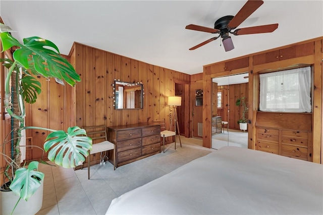 324 E Sutton St, Fayetteville, AR 72701 - tiled bedroom featuring wooden walls and ceiling fan