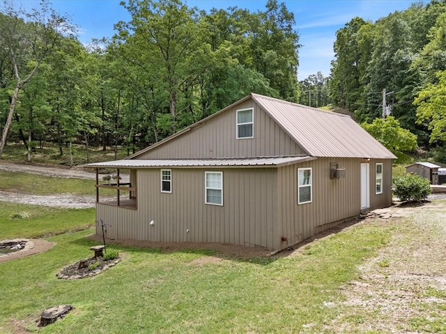 3139 Madison Unit 2405, Huntsville, AR 72740 - view of home's exterior featuring a yard and a metal roof