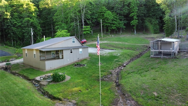 3139 Madison Unit 2405, Huntsville, AR 72740 - view of side of property featuring a lawn, a metal roof, and a forest view