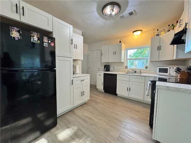 1105 Gibson St, Ozark, AR 72949 - kitchen featuring black appliances, under cabinet range hood, light wood-type flooring, white cabinets, and a sink