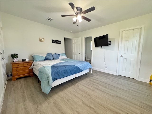 1105 Gibson St, Ozark, AR 72949 - bedroom with light wood-type flooring, baseboards, a ceiling fan, and connected bathroom