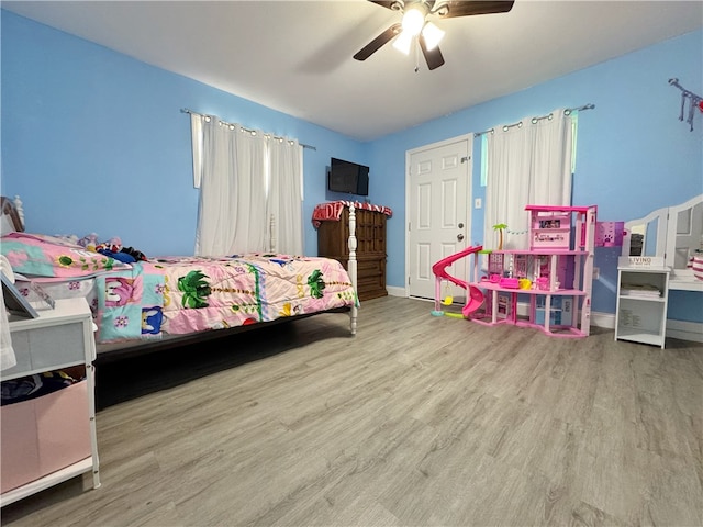 1105 Gibson St, Ozark, AR 72949 - bedroom with wood finished floors, baseboards, and a ceiling fan