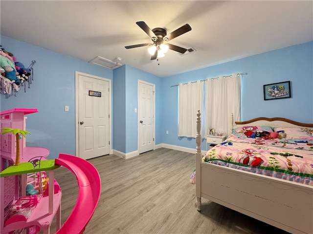 1105 Gibson St, Ozark, AR 72949 - bedroom with wood finished floors, baseboards, and ceiling fan