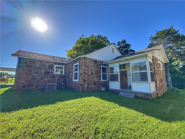 1105 Gibson St, Ozark, AR 72949 - back of property with cooling unit, stone siding, and a lawn