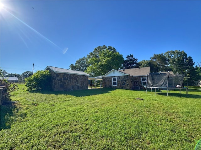 1105 Gibson St, Ozark, AR 72949 - view of green lawn featuring a trampoline