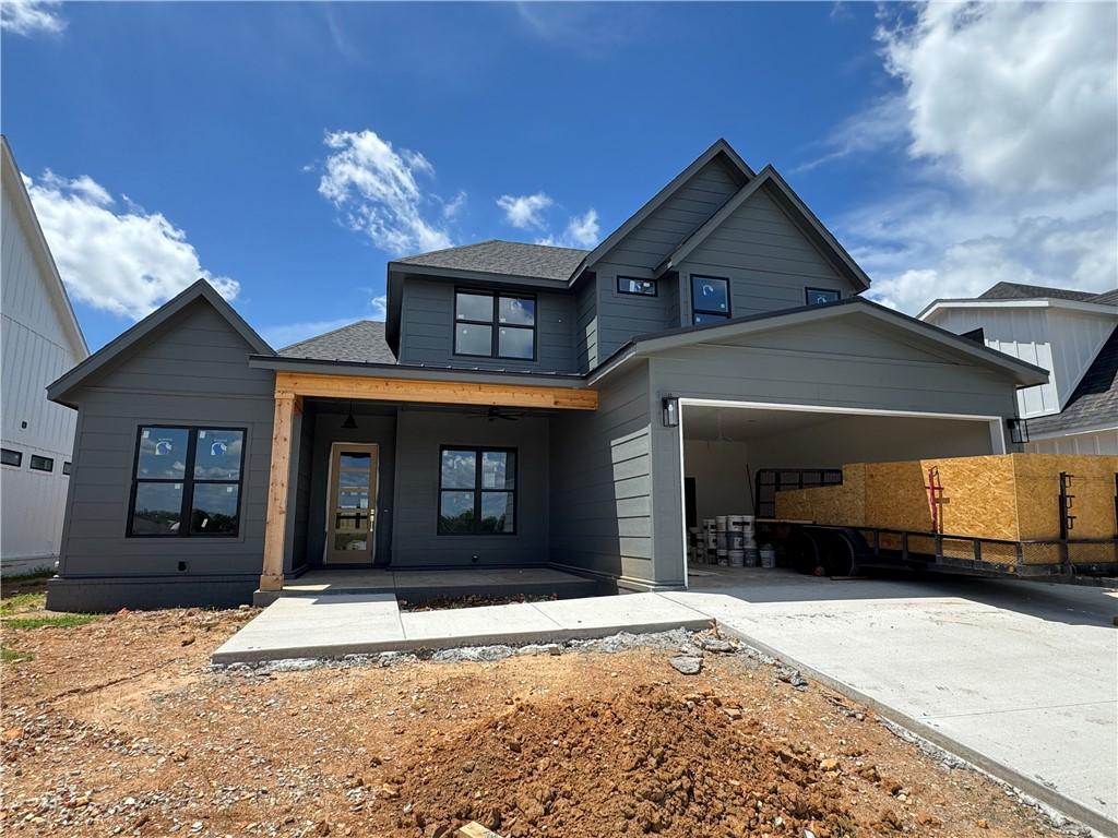 4110 Erin Dr, Rogers, AR 72758 - view of front of house with driveway, a garage, and a shingled roof