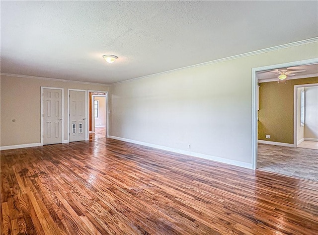 403 N Arch Ave, Green Forest, AR 72638 - spare room featuring wood finished floors, ornamental molding, baseboards, and a textured ceiling