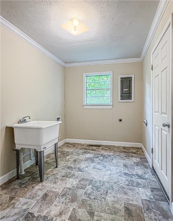 403 N Arch Ave, Green Forest, AR 72638 - washroom with ornamental molding, a textured ceiling, baseboards, washer hookup, and stone finish flooring