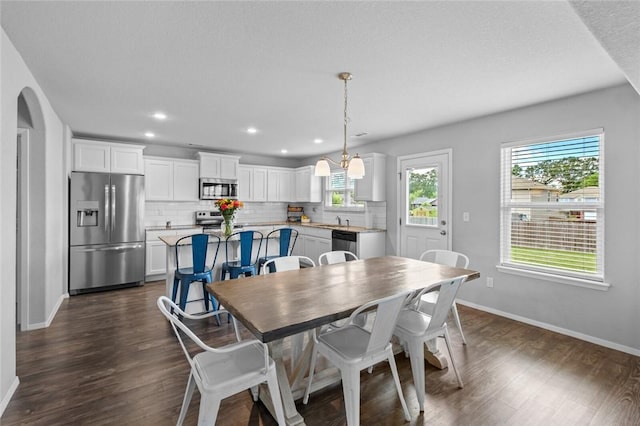 904 SW Loudon Dr, Bentonville, AR 72712 - dining space with baseboards, healthy amount of natural light, dark wood-style floors, and recessed lighting