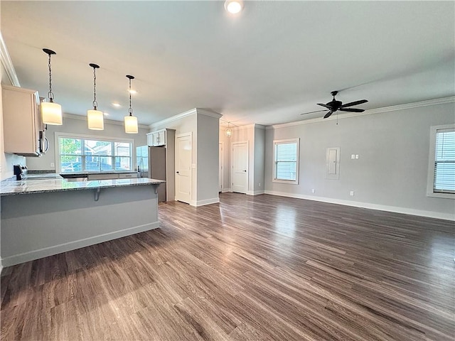 903 NE Heights Ln, Bentonville, AR 72712 - kitchen featuring ornamental molding, a peninsula, light stone countertops, a ceiling fan, and dark wood-style flooring