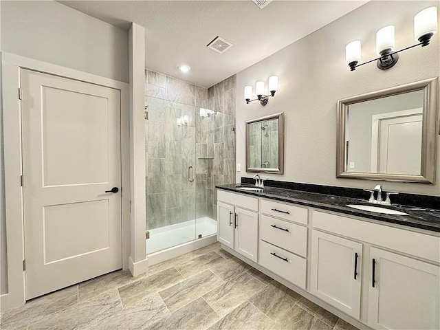 903 NE Heights Ln, Bentonville, AR 72712 - bathroom featuring a stall shower and double vanity