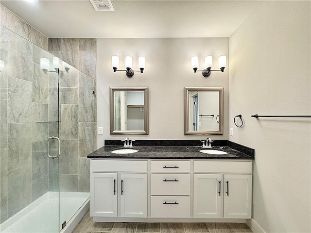 903 NE Heights Ln, Bentonville, AR 72712 - bathroom featuring a stall shower and double vanity