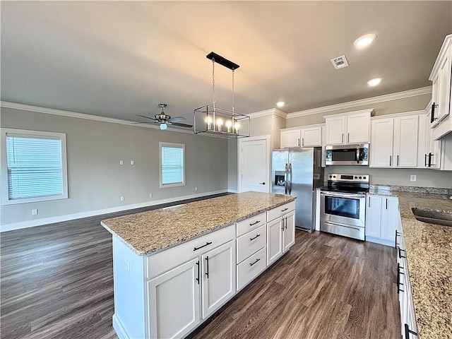 837 NE Heights Ln, Bentonville, AR 72712 - kitchen featuring appliances with stainless steel finishes, ornamental molding, ceiling fan, a center island, and dark wood-type flooring