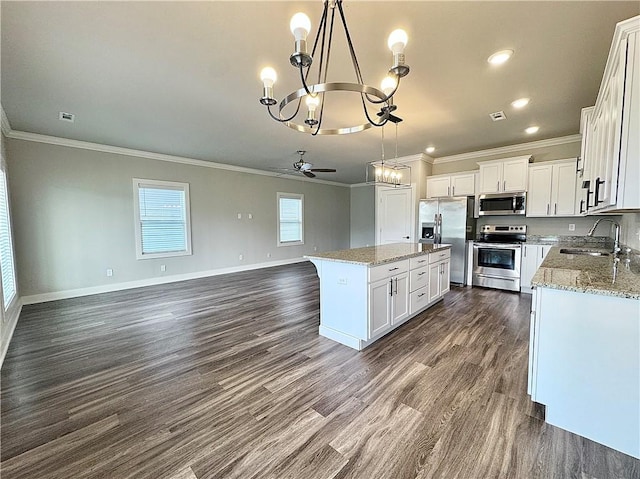 837 NE Heights Ln, Bentonville, AR 72712 - kitchen with stainless steel appliances, a sink, a chandelier, crown molding, and open floor plan