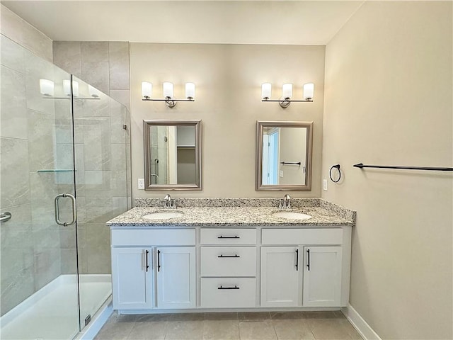 837 NE Heights Ln, Bentonville, AR 72712 - bathroom featuring a shower stall, double vanity, baseboards, and tile patterned flooring