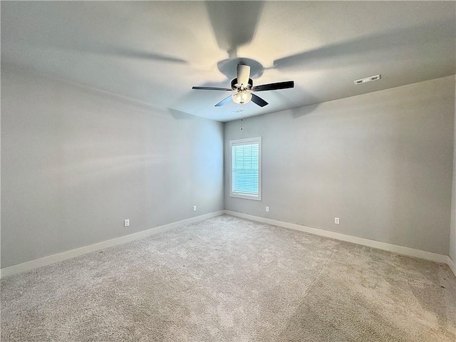 833 NE Heights Ln, Bentonville, AR 72712 - empty room featuring a ceiling fan, baseboards, and light carpet