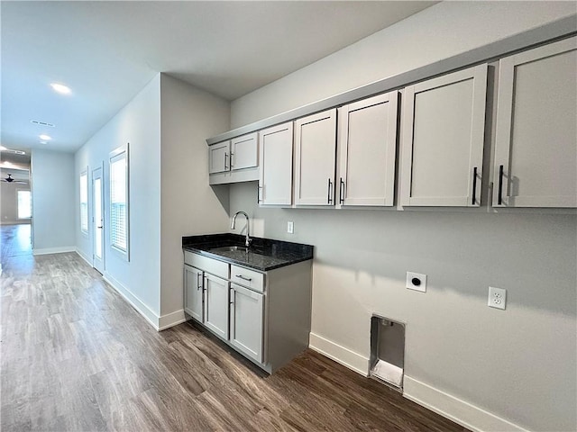 833 NE Heights Ln, Bentonville, AR 72712 - laundry room featuring electric dryer hookup, baseboards, dark wood-style floors, cabinet space, and recessed lighting