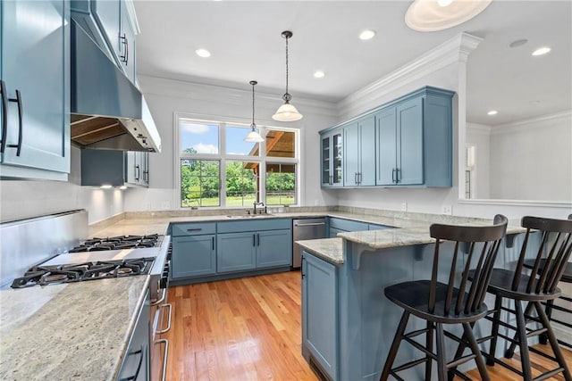 15071 Crossover Rd, Gravette, AR 72736 - kitchen with gas range oven, a breakfast bar area, stainless steel dishwasher, a sink, and under cabinet range hood