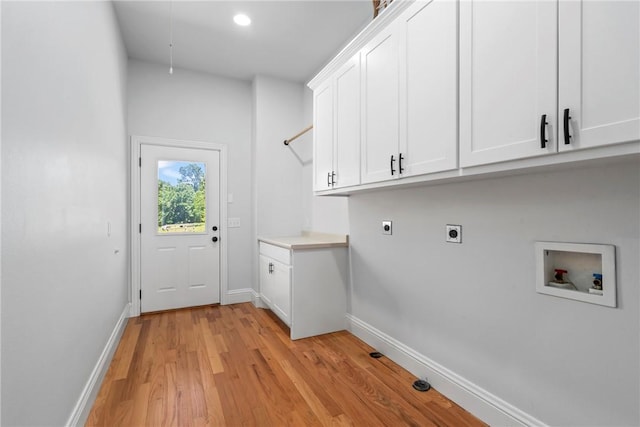 15071 Crossover Rd, Gravette, AR 72736 - washroom featuring hookup for an electric dryer, hookup for a washing machine, cabinet space, baseboards, and light wood-style floors