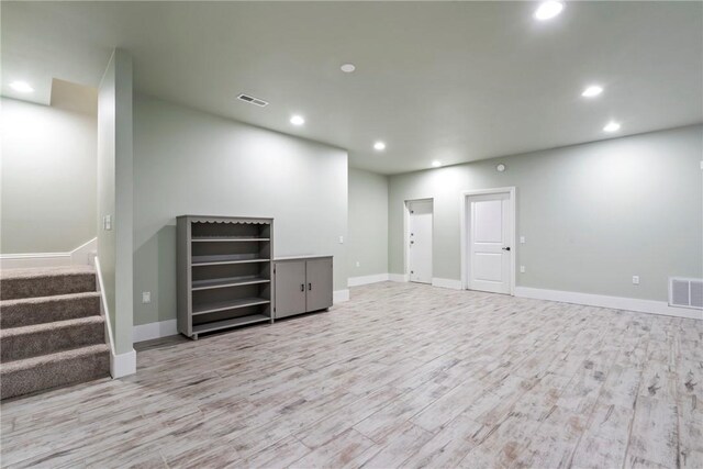 15071 Crossover Rd, Gravette, AR 72736 - below grade area with recessed lighting, light wood-style floors, baseboards, and stairway