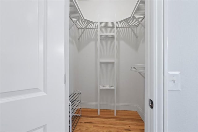 15071 Crossover Rd, Gravette, AR 72736 - walk in closet featuring wood finished floors