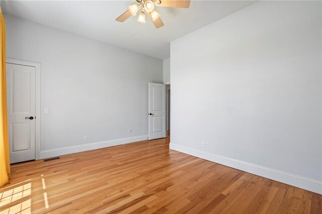 15071 Crossover Rd, Gravette, AR 72736 - spare room with a ceiling fan, light wood-type flooring, and baseboards