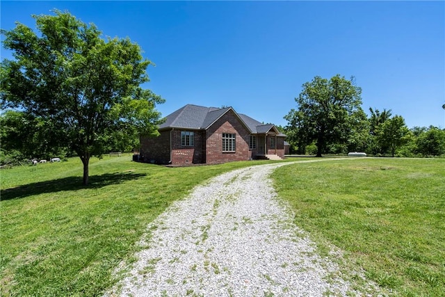 15071 Crossover Rd, Gravette, AR 72736 - view of front facade featuring brick siding, driveway, and a front yard