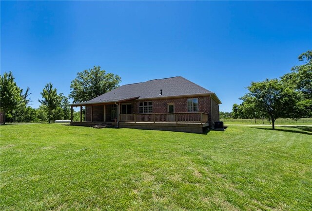 15071 Crossover Rd, Gravette, AR 72736 - rear view of property with a deck, a lawn, cooling unit, and brick siding