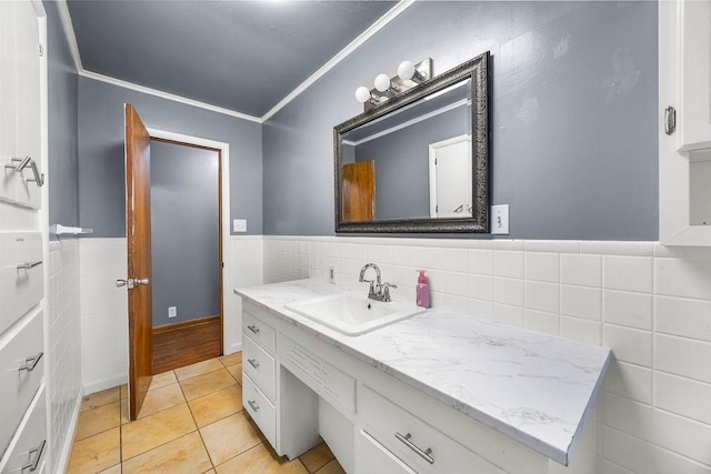 713 Young St, Springdale, AR 72764 - bathroom featuring vanity, tile walls, crown molding, tile patterned floors, and a wainscoted wall