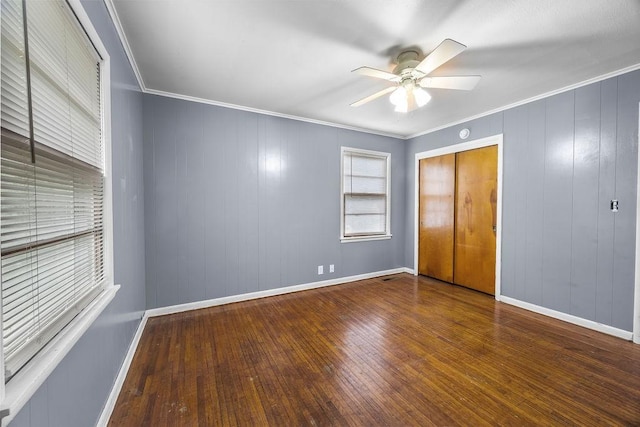 713 Young St, Springdale, AR 72764 - unfurnished bedroom featuring hardwood / wood-style floors, baseboards, ornamental molding, a closet, and a ceiling fan