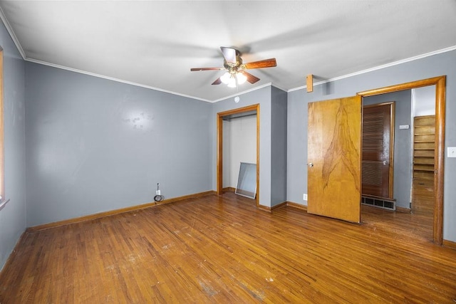 713 Young St, Springdale, AR 72764 - unfurnished bedroom featuring wood finished floors, baseboards, a closet, and ornamental molding
